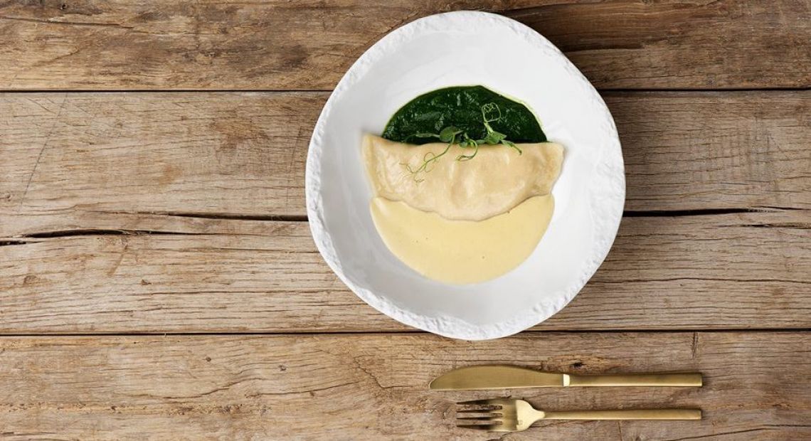 dumpling with sauce served on wooden table