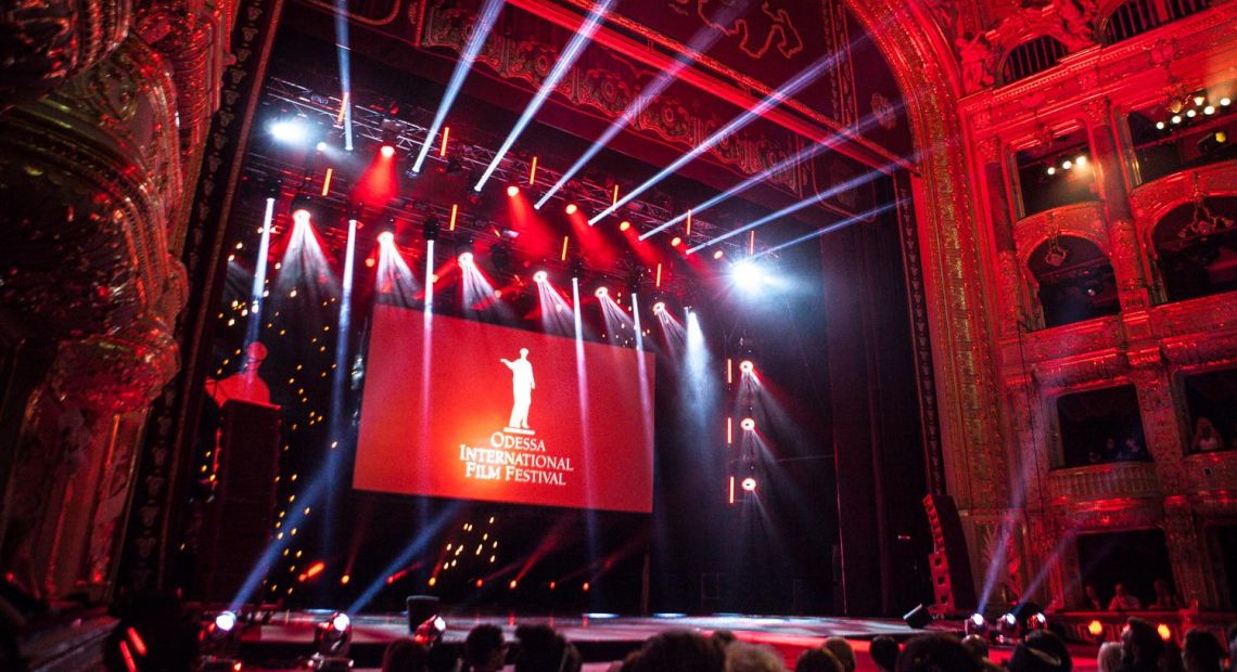 large movie screen in opera hall with colorful illumination