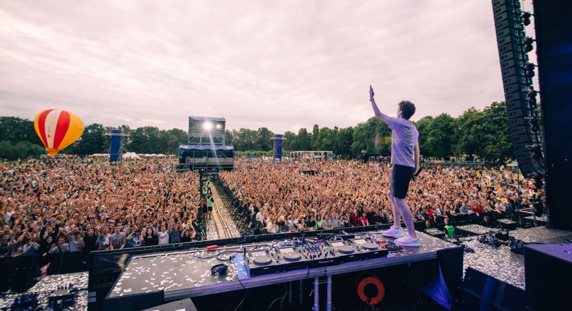 dj playing in front of crowd on festival