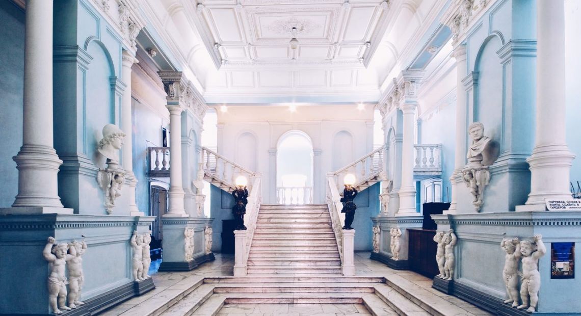 museum hall with sculptures and stairs