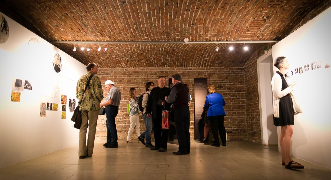 people looking at photos at art gallery