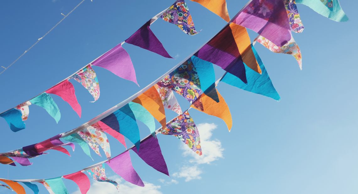 colorful festive bunting with blue sky on background