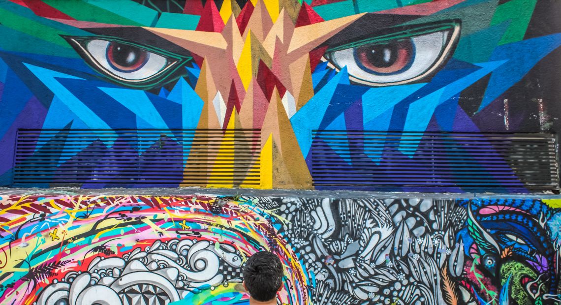 Man looking at bright street art