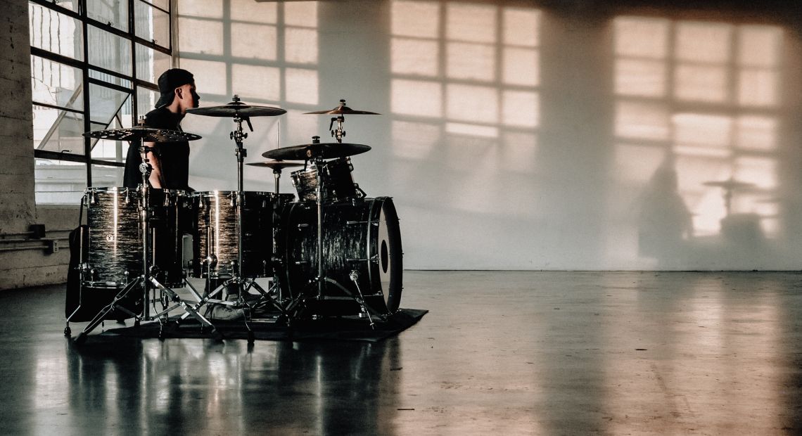 Drummer in a grey room