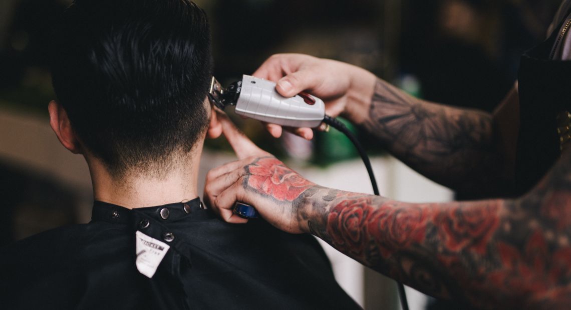 Man getting a buzz cut at a barbershop