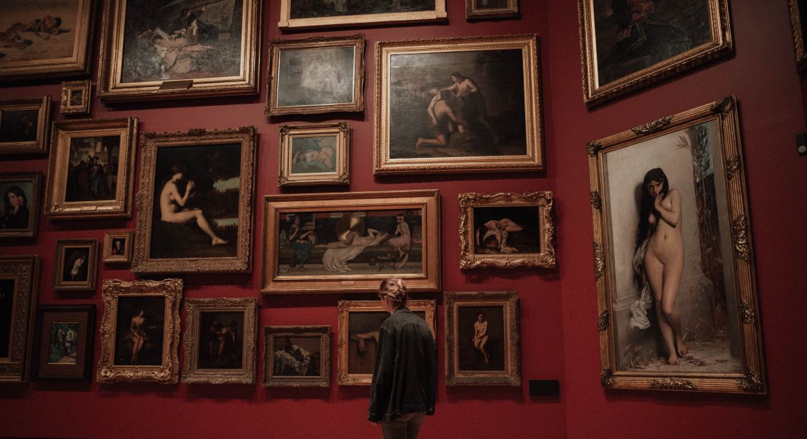 Girl viewing paintings in a gallery