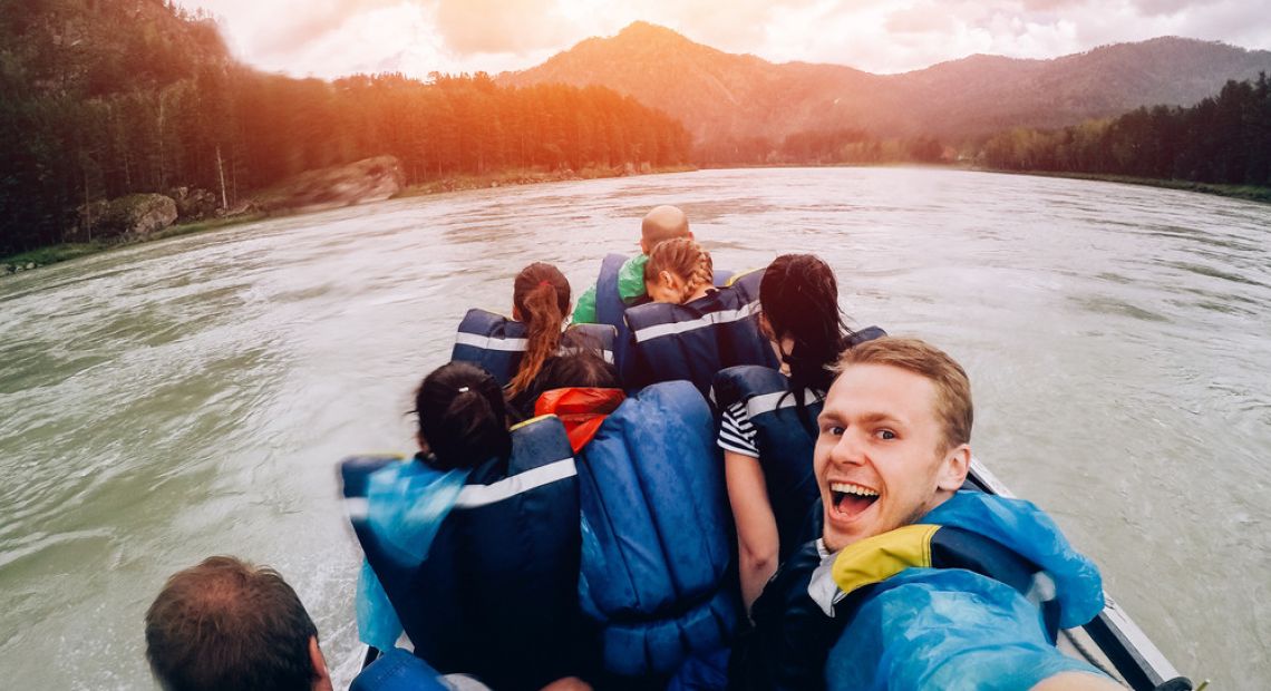 people doing selfie on raft