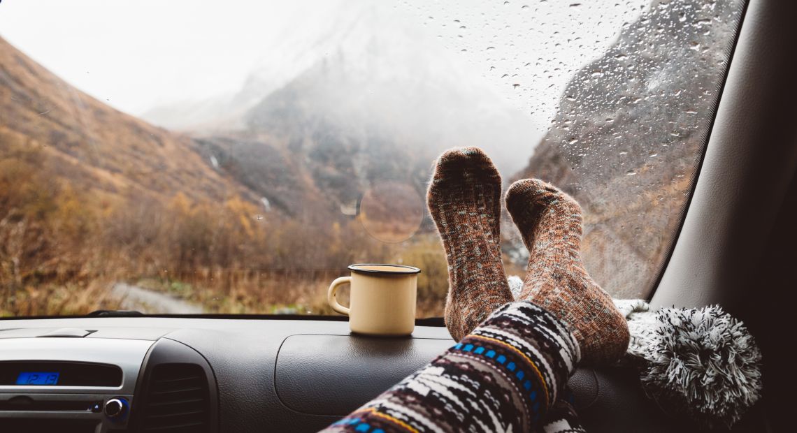 Person in warm socks on an autumn trip