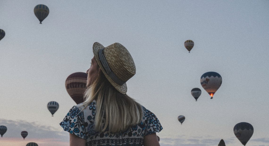 Girl watching hot air balloons in Turkey