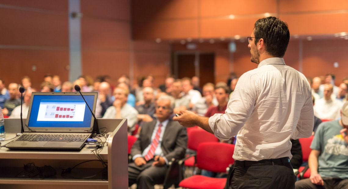 Man delivering a lecture on a business event