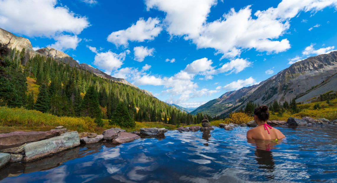 people bathing in mountain lake