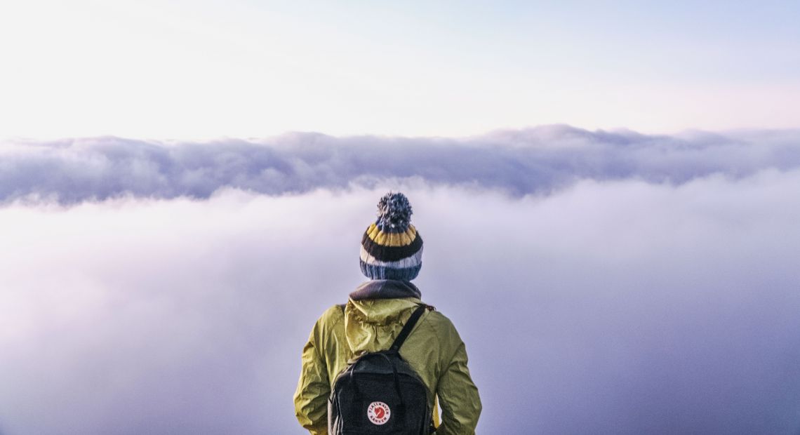 Traveler with a backpack looking at the horizon