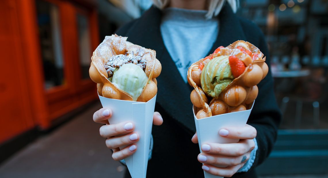 Woman holding waffles with ice cream