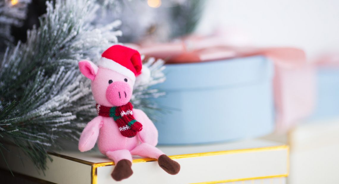 Plush piglet in a Santa hat