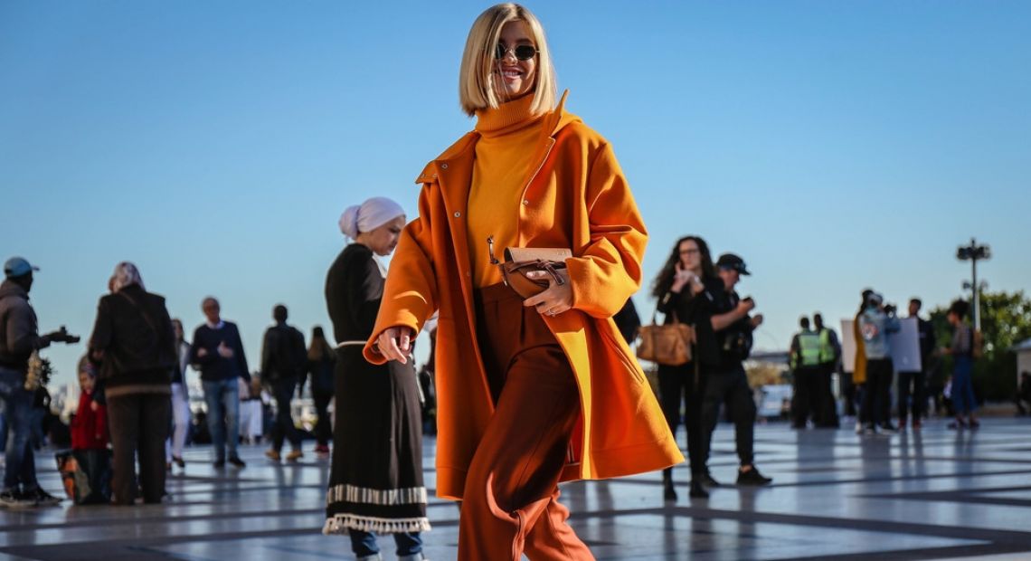 Woman in a bright orange coat on Paris Fashion Week 2018