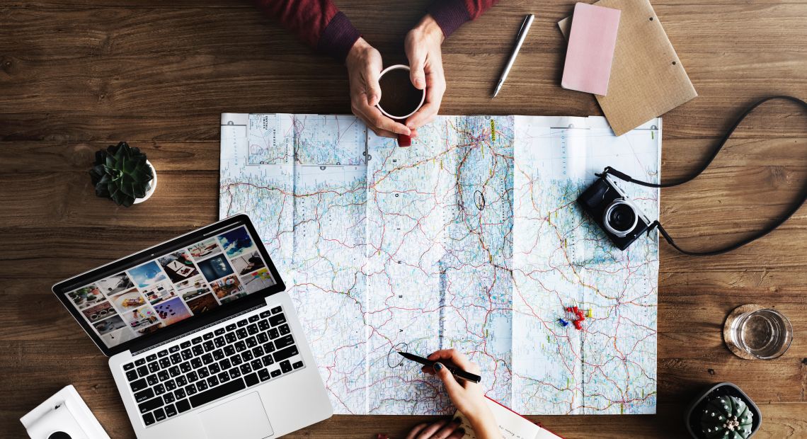 Maps and laptops to prepare for traveling