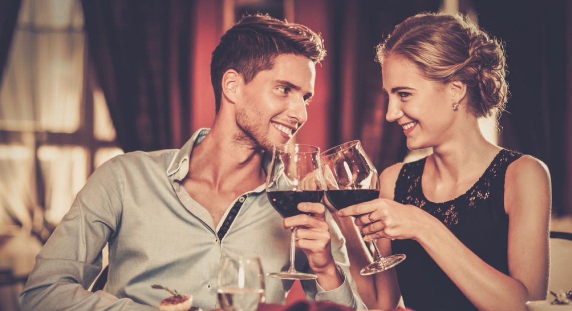 young couple drinking wine in restaurant