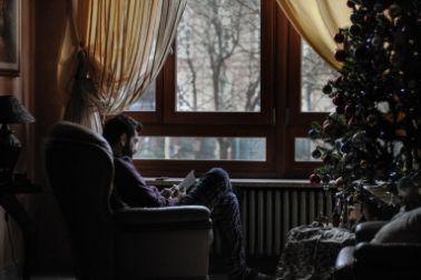 Man sitting by the Christmas tree