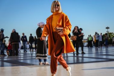 Woman in a bright orange coat on Paris Fashion Week 2018