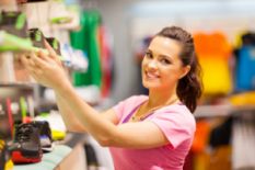 woman choosing sport shoes in store