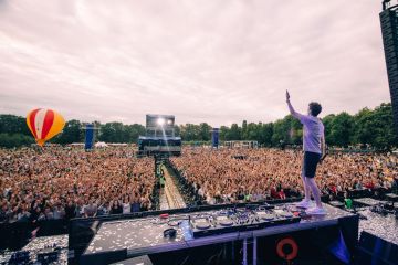 dj playing in front of crowd on festival