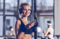 young girl in gym in headphones