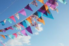colorful festive bunting with blue sky on background