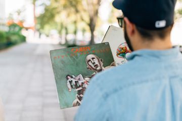 Man holding a Queen vintage vinyl