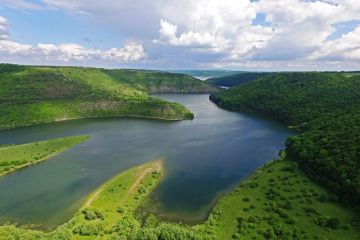 river surrounded by green hills