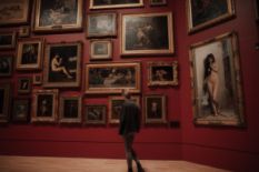 Girl viewing paintings in a gallery