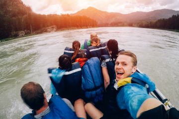 people doing selfie on raft