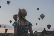 Girl watching hot air balloons in Turkey