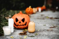 Jack-o-lantern and candles on the ground