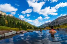 people bathing in mountain lake