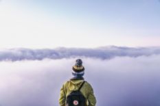 Traveler with a backpack looking at the horizon