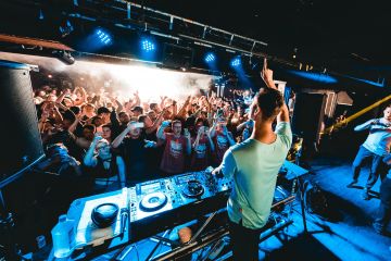 people dancing at party with DJ