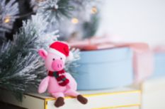 Plush piglet in a Santa hat