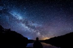 man looking at night starry sky