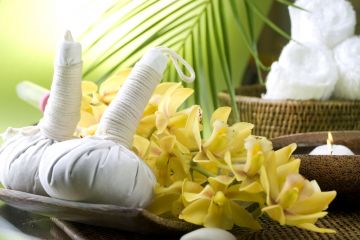 candles, towels and flowers for thai massage