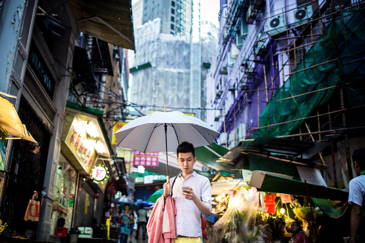 best travel apps man with phone umbrella.adapt.1190.1