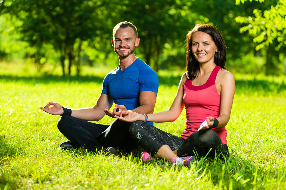Couple on an open-air yoga session