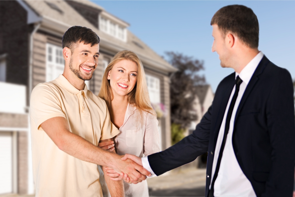 couple in front of the house