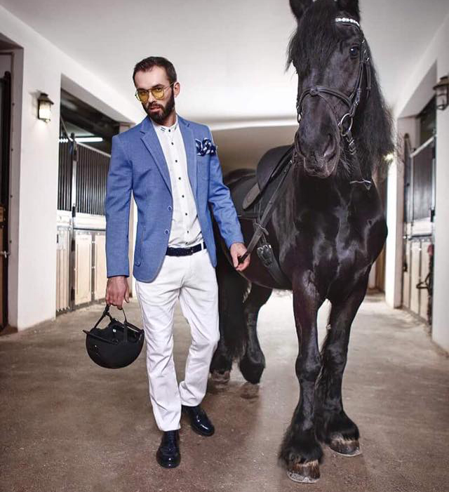 man with black horse