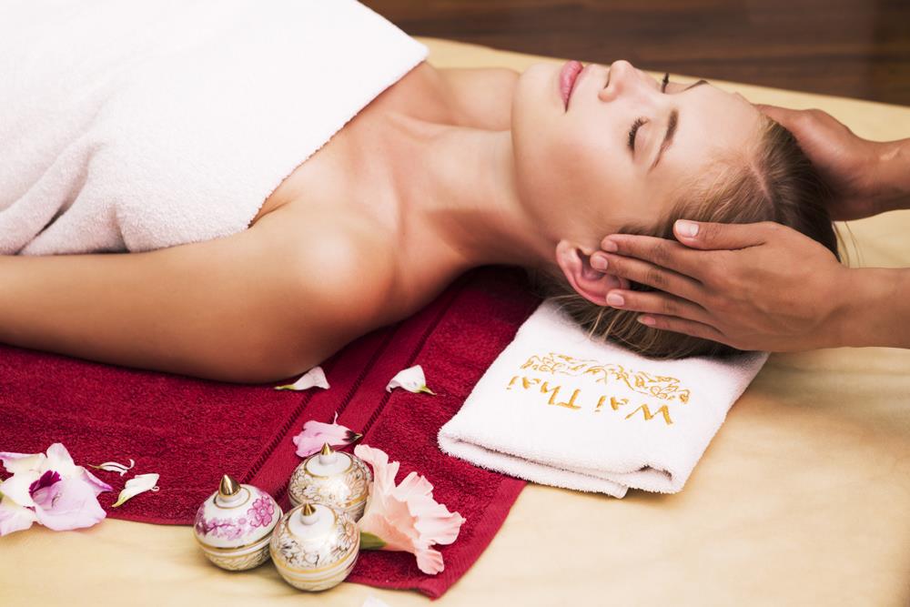 woman receiving massage of head