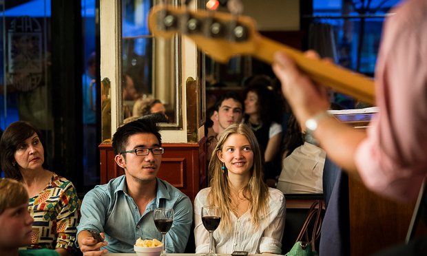 man and woman drinking wine and listening to music