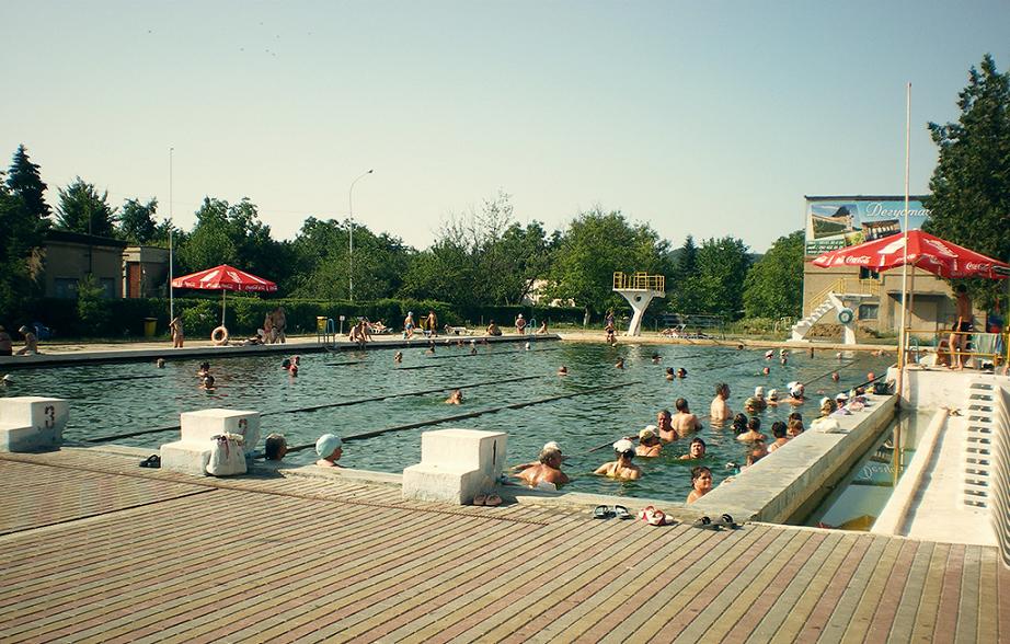 many people swimming in open air pool