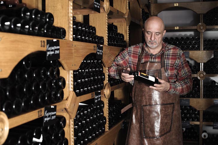 vigneron holding a bottle of wine