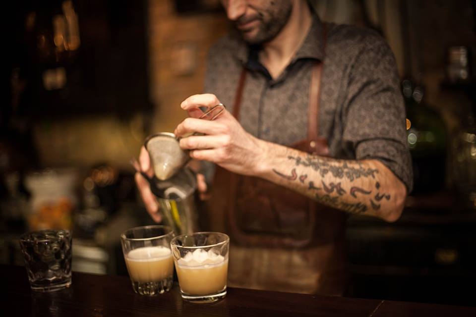 Bartender works on a shot in Alchemist Bar