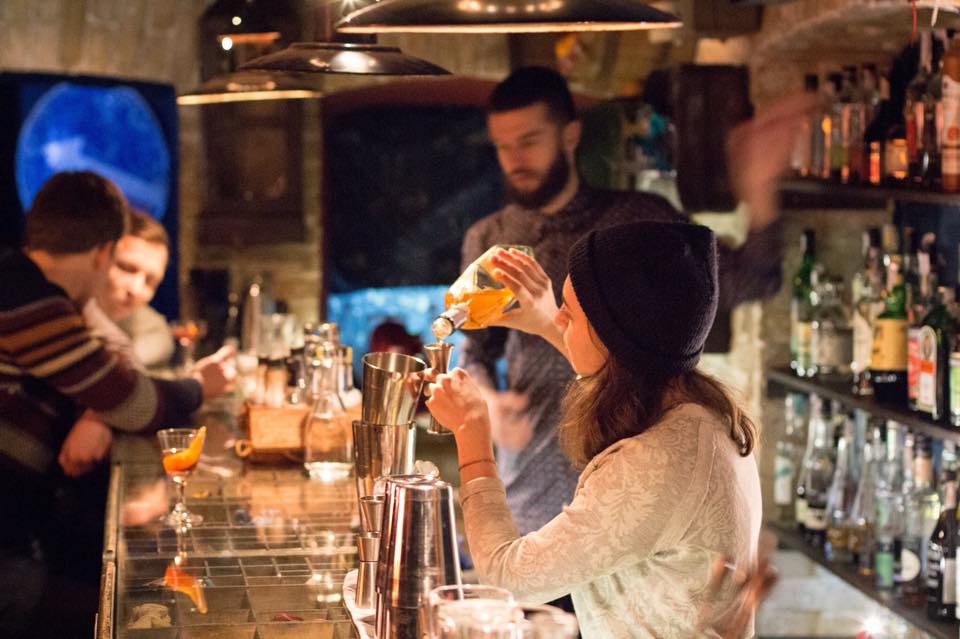 Girl pouring a drink in a bar