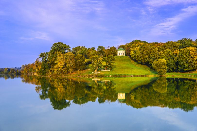 hill with alcove near lake in autumn